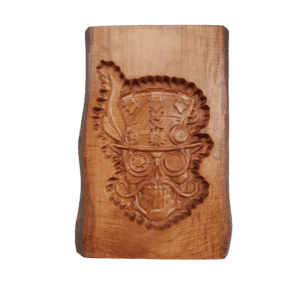 A wooden plaque with a carved face on it.