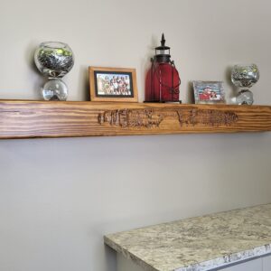 Wooden shelf with carved wildlife design.
